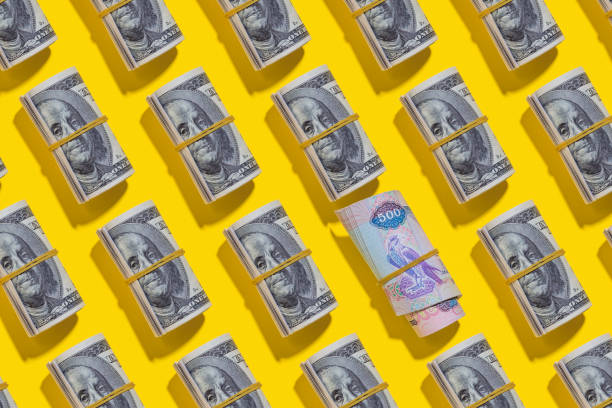 istock Emirati dirham and American dollar rolls on yellow background 1212265060