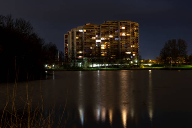 Residential building reflection on pond in Wolfsburg night
