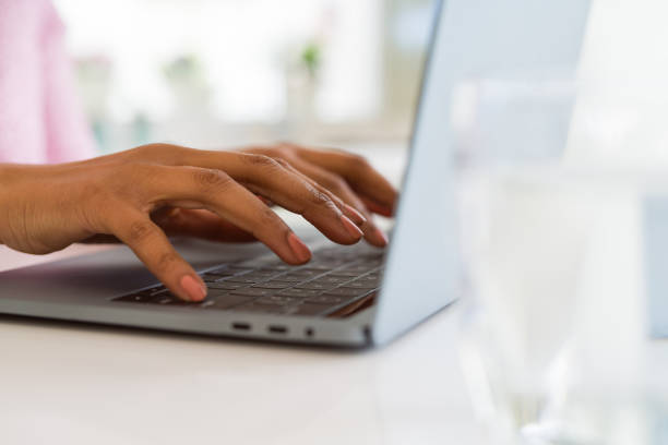 istock Close up of young woman working typing using laptop 1212268486