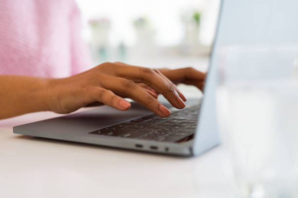 istock Close up of young woman working typing using laptop 1212268493
