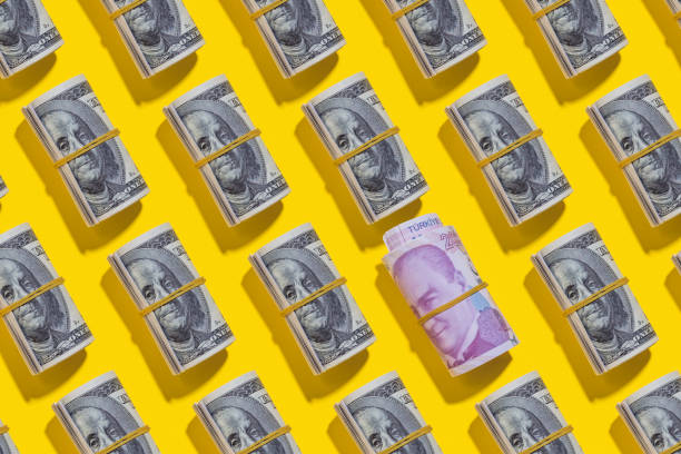 istock Turkish lira and American dollar rolls on yellow background 1212268752