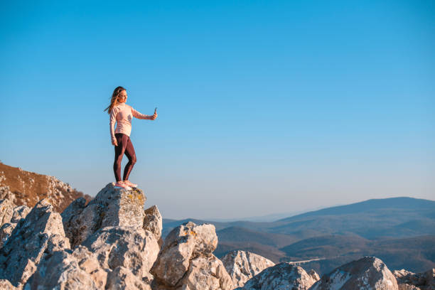 istock Woman taking a selfie on a mountain 1212268773