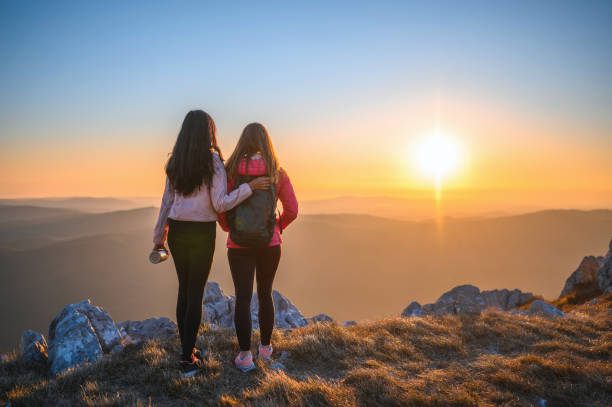 istock Sportswomen Looking at Sunset in the Mountains 1212269975