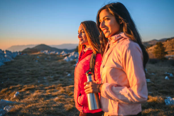 istock Sportswomen Looking at Sunset in the Mountains 1212270001