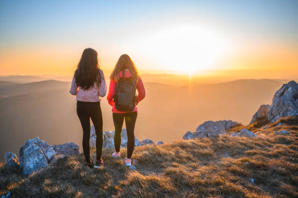 istock Sportswomen Looking at Sunset in the Mountains 1212270019