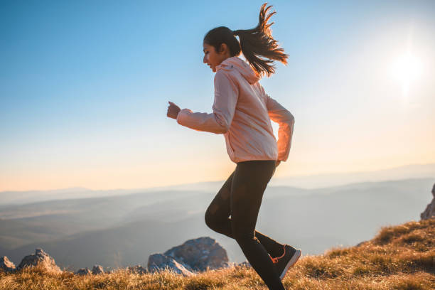 istock Indian sportswoman running on a mountain plain 1212270107