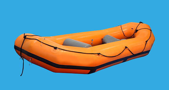 Orange rubber inflatable boat isolated on blue background