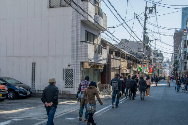 People are walking on street toward Shitennoji in Osaka Tennoji area. Osaka, Japan- 01 Dec, 2019: People are walking on street toward Shitennoji in Osaka Tennoji area. shitenno ji stock pictures, royalty-free photos & images