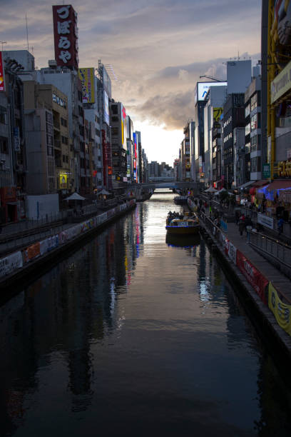 canal and advertising billboard in dontonbori - architecture travel destinations vertical outdoors imagens e fotografias de stock