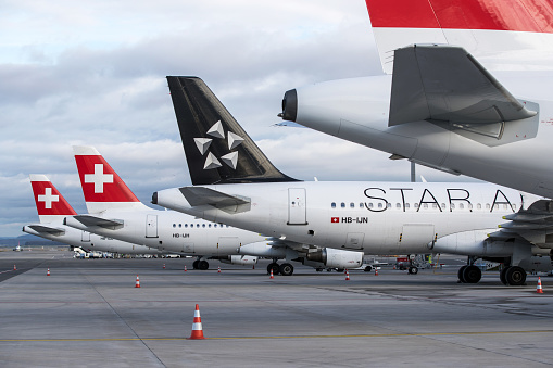 Zurich, Switzerland - March 12, 2020: Overview of Zurich Airport with Swiss International Air Lines airplanes parked on remote stands. Thousands of flights have been cancelled worldwide as airlines struggle to cope with a slump in demand caused by the coronavirus outbreak.