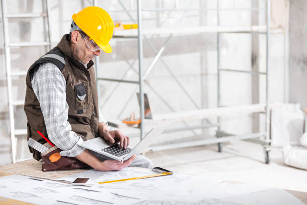 Building supervisor working on his laptop stock photo