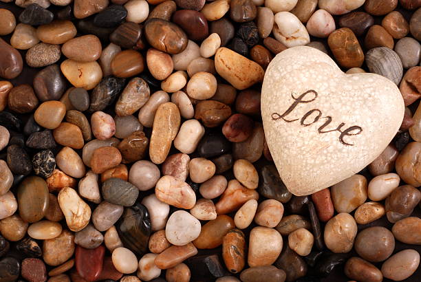 Heart shape pebbles frame isolated on white background