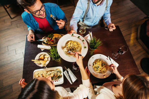 istock Young people eating lunch at restaurant 1212276729