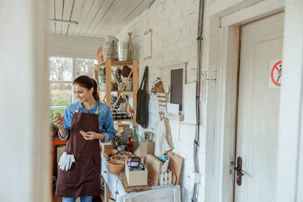 istock Pleased female herbalist with vials standing indoors 1212279633