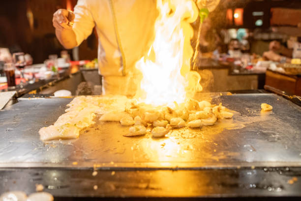istock Teppanyaki Chef Cooking Japanese Seafood Shrimp With Fire 1212281072