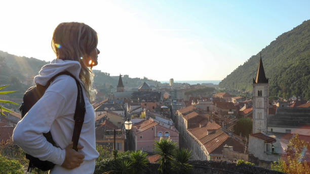 istock Female hiker walks up cobble stone path at sunrise 1212281853
