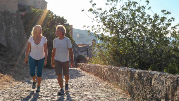 istock Mature couple hike up cobble stone path at sunrise 1212281911