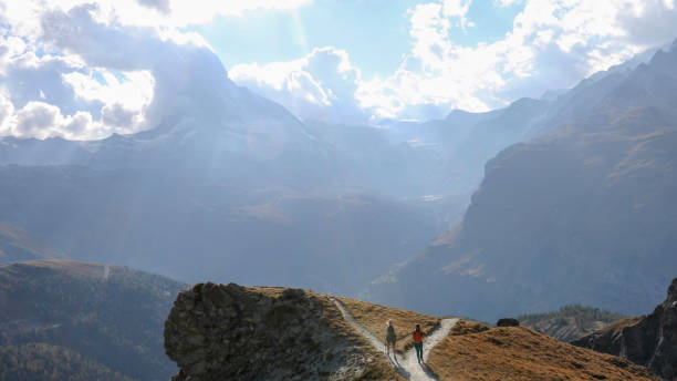 istock Female hikers choose different paths to hike along 1212282506