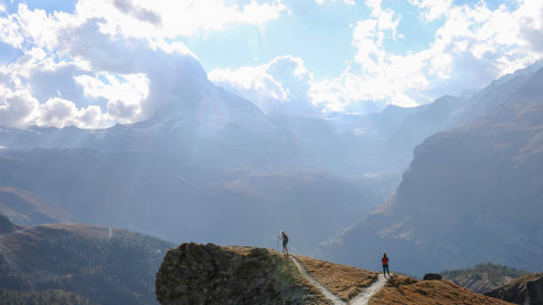 istock Female hikers choose different paths to hike along 1212282533