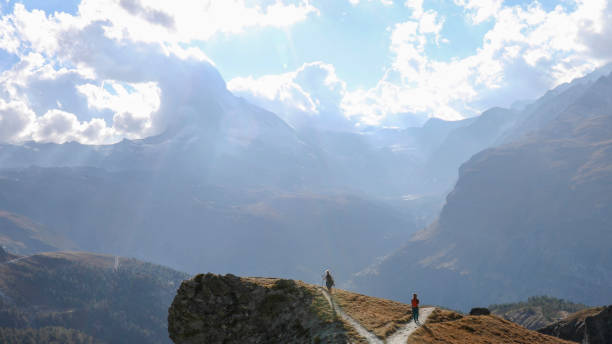 istock Female hikers choose different paths to hike along 1212282550