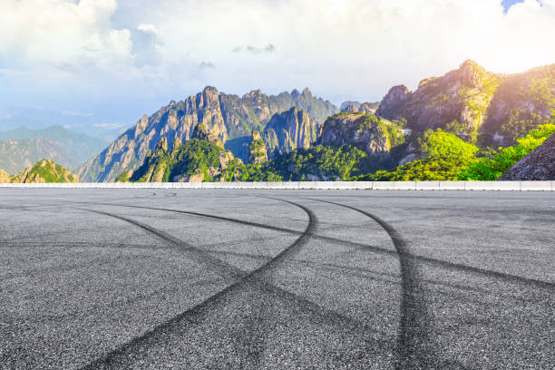 istock Race track road and green mountain with beautiful clouds. 1212284080