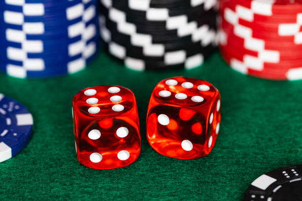 A Boxcar Sixes Roll On A Green Felt Craps Table With Stacks Of Red Black And Blue Betting Chips In The Background And A Few Stray Chips Around The ...