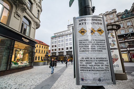Picture of a poster in the city center of Prague, Czech Republic, warning tourists and reminding that drinking alcohol in public places is forbidden.