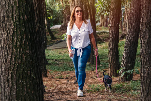 istock Woman walking with the little dog 1212289465