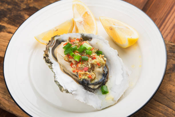 istock Barbecue overbaked fresh opened oyster with garlic, 1212294105
