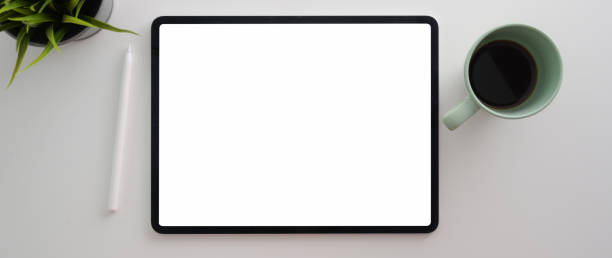 istock Cropped shot of workspace with blank screen tablet, decoration and coffee cup 1212296720