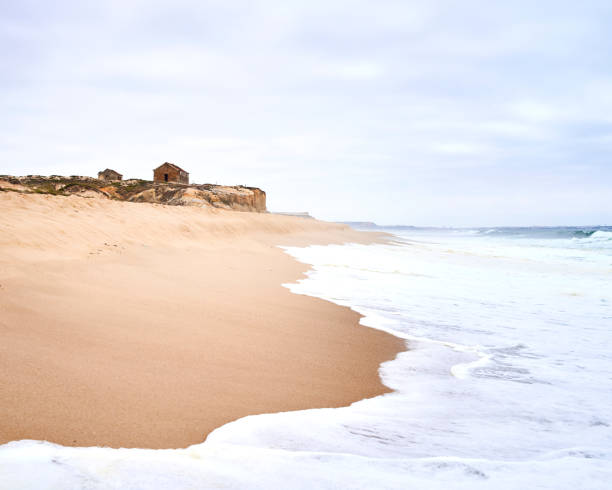 istock Old building over the cliff overlooking to the beach on a cloudy day 1212301010