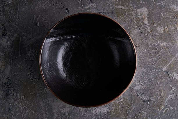 istock Black dishes on a gray background Vertcal Copy space 1212301752