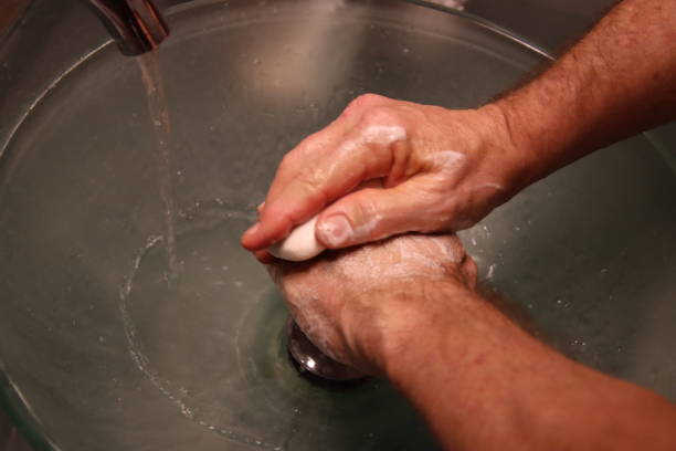 istock Person washing hands with soap and water. 1212302929