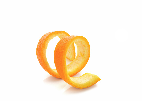 Hand holding cut in half tangerine, healthy eating citrus fruit