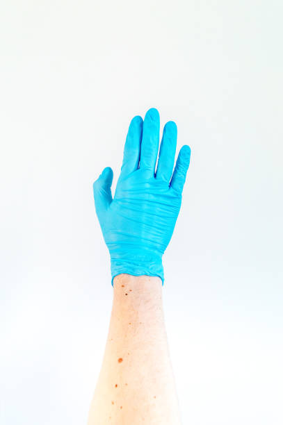 istock Hand in blue medical glove on white background. 1212303634