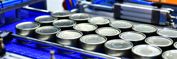 istock Canned food products on conveyor belt in distribution warehouse. 1212304591