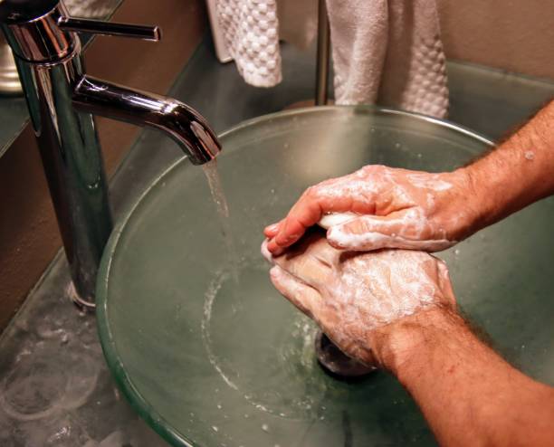 istock Person washing hands with soap and water. 1212306891