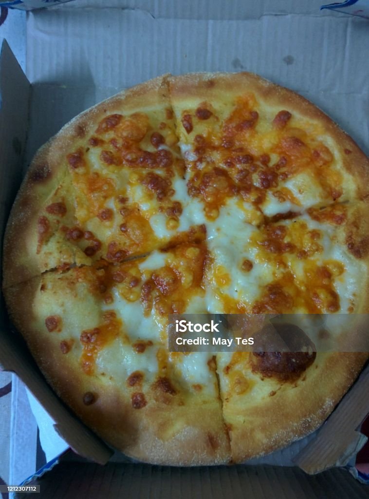 Cheesy Pizza from Domino's India Can't get any cheesier. For all the cheese lovers out there. Baked Stock Photo