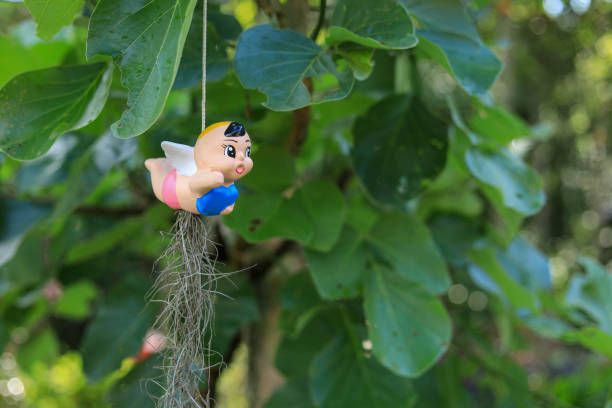 A close up shot of a little girl holding a plant growing in soil.