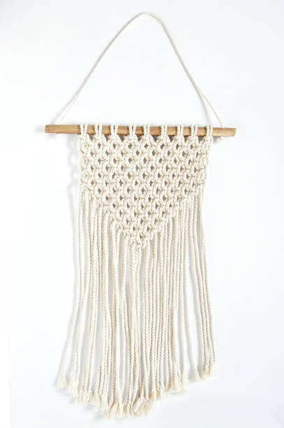 Object, macrame cotton on white background. Decorative handmade hobby interior for hanging on wall . DIY and hobby concept.
