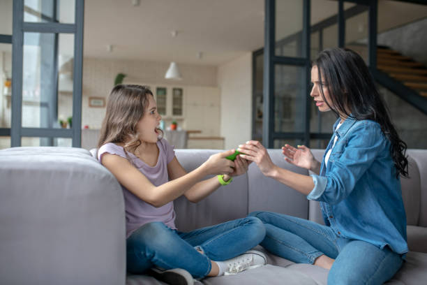 istock Mom and daughter having an agrument about using internet 1212309680