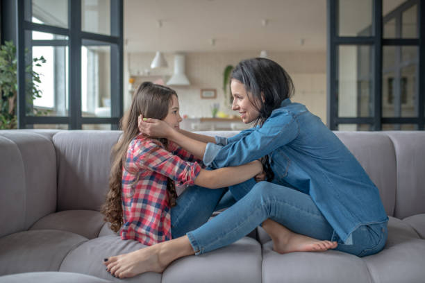istock Mom touching her daughters face with care 1212309691
