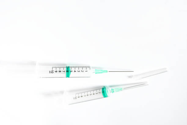 istock Empty transparent plastic syringe size 10 ml. on white background with space for text. A tube for sucking in and ejecting liquid in a thin stream. Healthy care,medical and beauty object concept. 1212311671
