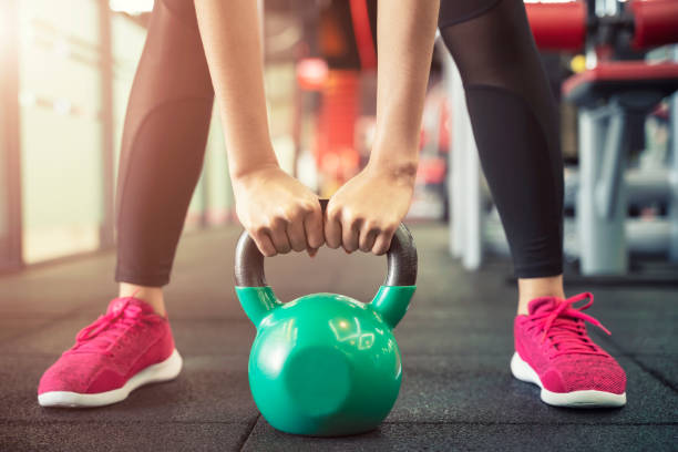 closeup of people exercise with kettlebell at gym. sport workout and fitness. - kettle bell activity aerobics athlete imagens e fotografias de stock