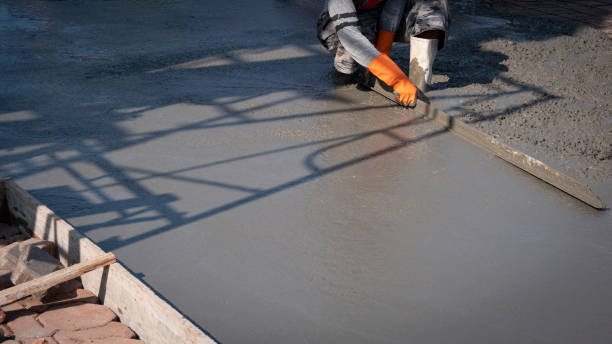 istock construction worker using long triangle trowel to plastering cement on the floor 1212315597