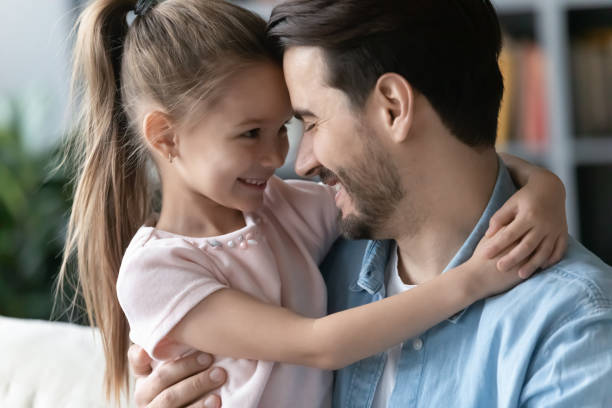 istock Loving young dad relax at home with little daughter 1212315815