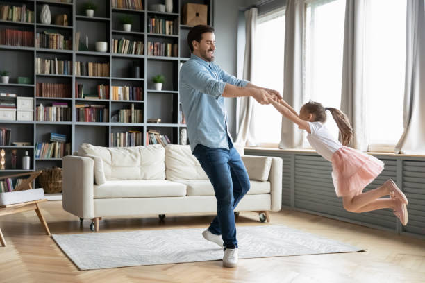 istock Young father dancing with happy preschooler daughter 1212315854