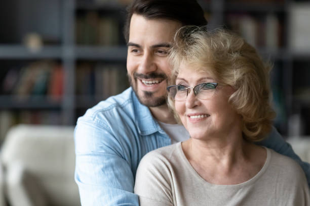 istock Hopeful senior mom and adult son visualize together 1212315859
