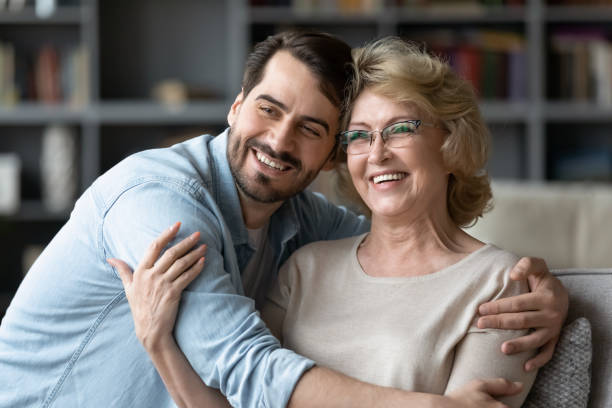 istock Smiling adult son and senior mother visualize looking in distance 1212315868