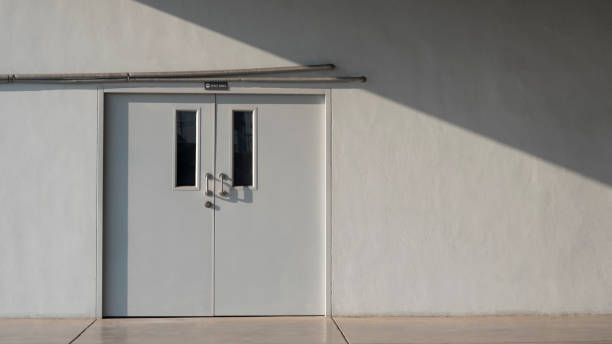 istock staff room door and air pipelines with sunlight and shadow on grey cement wall surface 1212316537